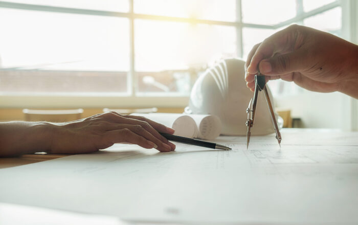 Hands of Engineer working on blueprint,Construction concept. Engineering tools.Vintage tone retro filter effect,soft focus(selective focus)