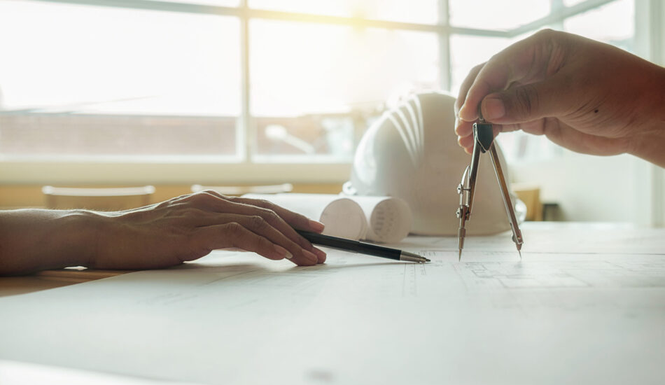 Hands of Engineer working on blueprint,Construction concept. Engineering tools.Vintage tone retro filter effect,soft focus(selective focus)